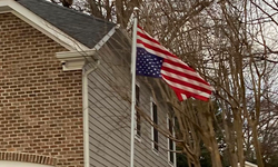 High judge hangs inverted flag in front of his house